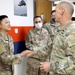 Brig. Gen. Ronald Burkett visits Camp Buehring and coins three Task Force Phoenix Soldiers