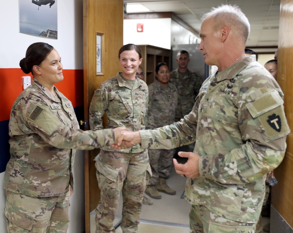 Brig. Gen. Ronald Burkett visits Camp Buehring and coins three Task Force Phoenix Soldiers