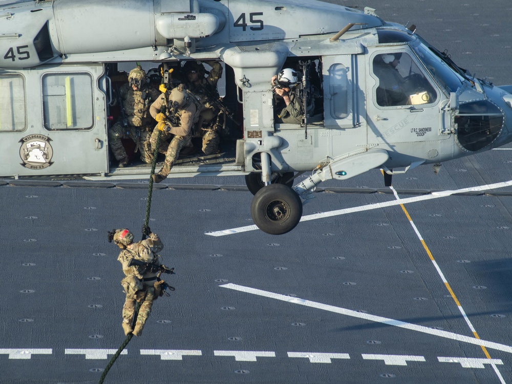 HSC 23 conducts fast rope excersises with USCG MSRT aboard USS Miguel Keith