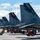 Combat aircraft integrate in Hawaii for exercise Sentry Aloha-21 A row of U.S. Air Force F-15 Eagle fighter jets belonging to the 144th Fighter Wing, California Air National Guard, based in Fresno, are lined up on a flight line tarmac. Ground crew personnel are actively performing maintenance and pre-flight checks on the aircraft. The tail markings identify at least three aircraft with serial numbers AF 84-017, AF 86-144, and AF 82-028, all marked 'CALIFORNIA' and 'FRESNO'.