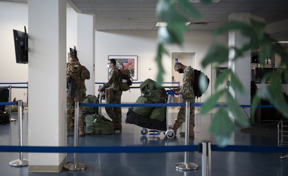 U.S. Airmen assigned to the 821st Contingency Response Group wait to board