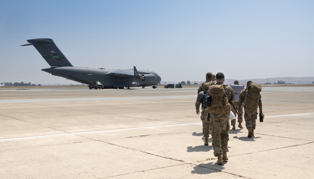 U.S. Airmen assigned to the 821st Contingency Response Group make their way to a C-17 Globemaster III