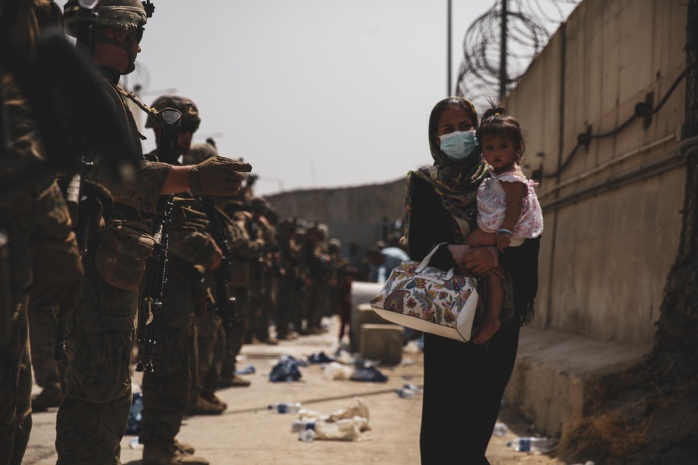 Marines with the 24th Expeditionary Unit (MEU) guide an evacuee during an evacuation at Hamid Karzai International Airport