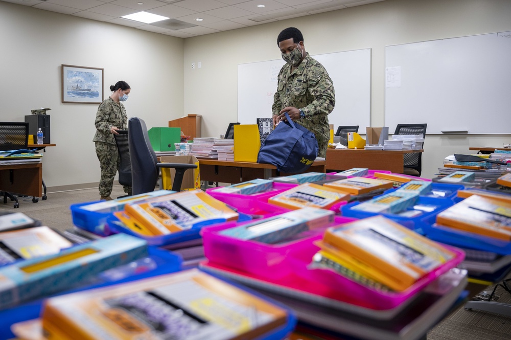 Sailors build kits for a back to school supplies drive