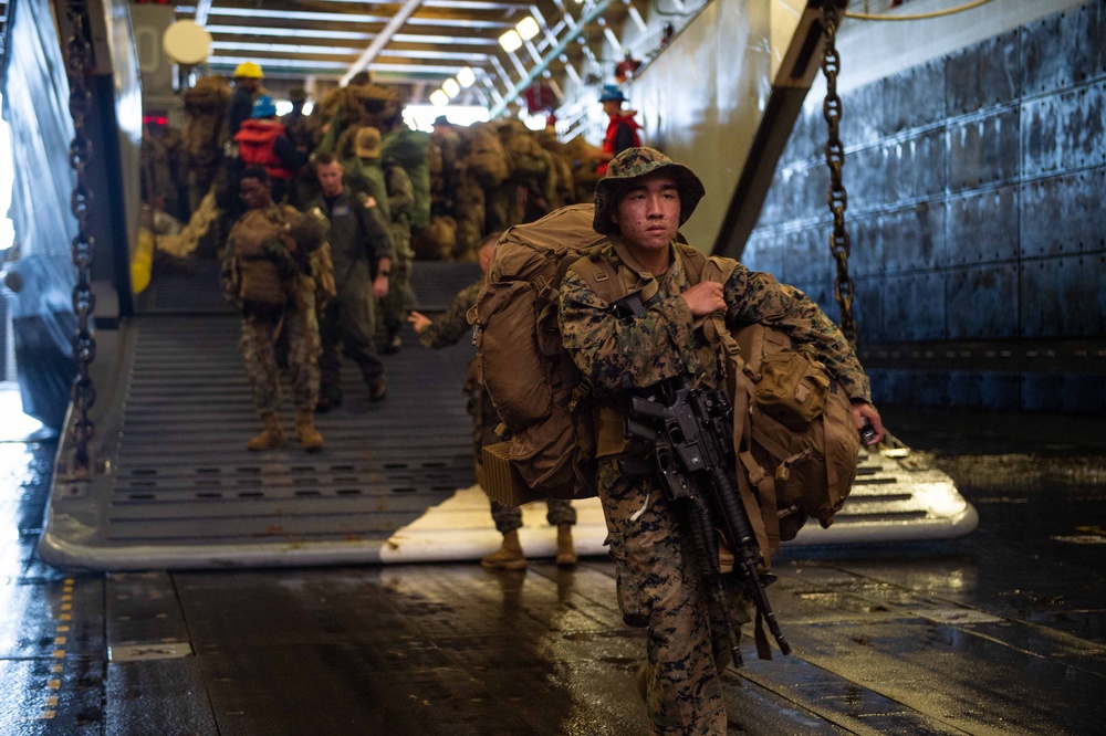 Marines Disembark a Landing Craft Aboard USS Arlington