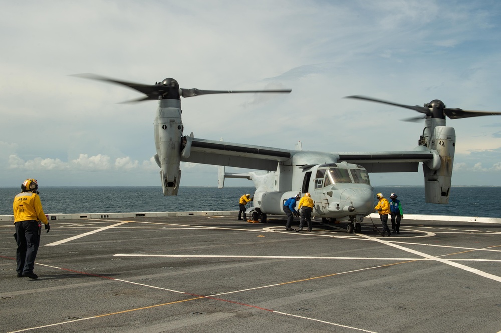 USS Arlington Sailors Place Chocks and Chains Onto a MV-22 Osprey