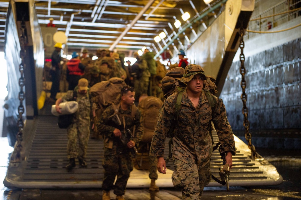 Marines Disembark a Landing Craft Aboard USS Arlington