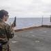 Sailors and Marines have a marksman competition on the USS America LHA 6.
