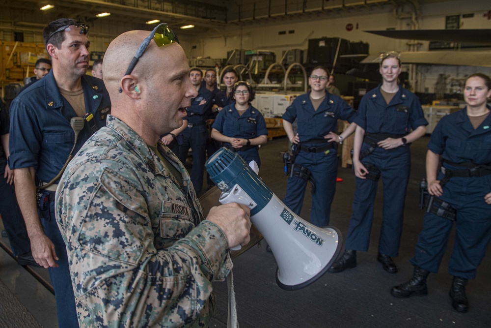 Sailors and Marines have a marksman competition on the USS America LHA 6.