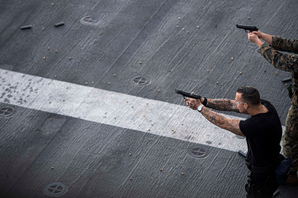 Sailors and Marines have a marksman competition on the USS America LHA 6.