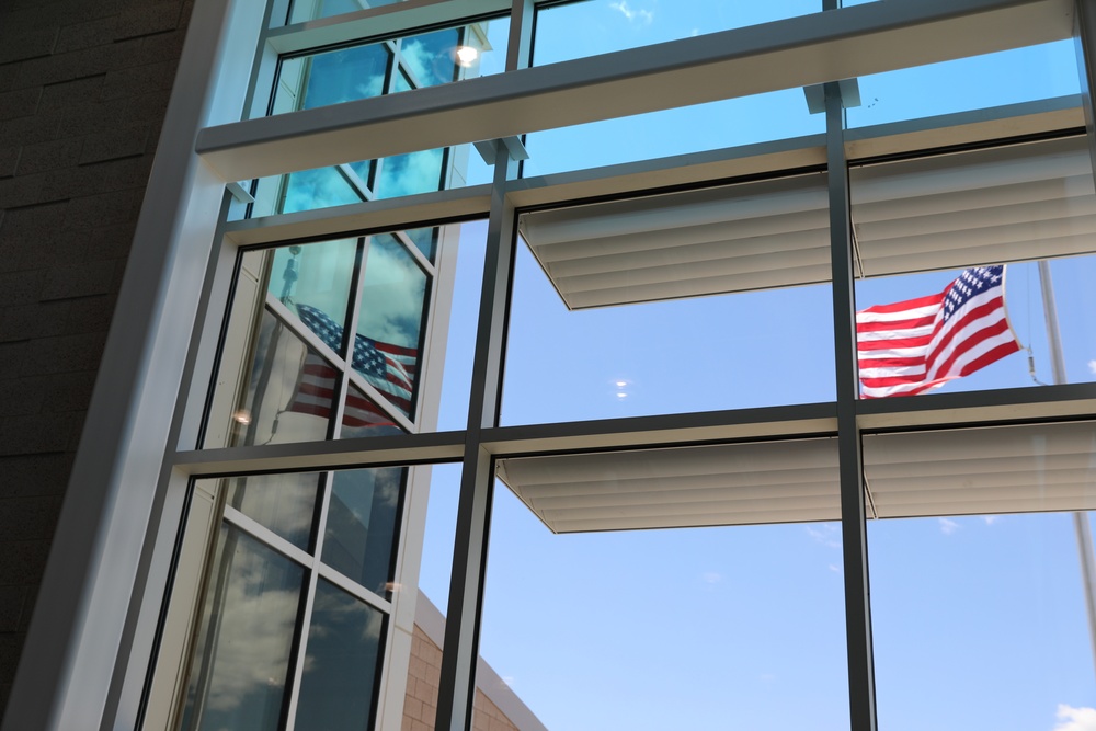 The American Flag is reflected in the efficiency glass used in the new Army Aviation Readiness Center for the South Dakota National Guard.