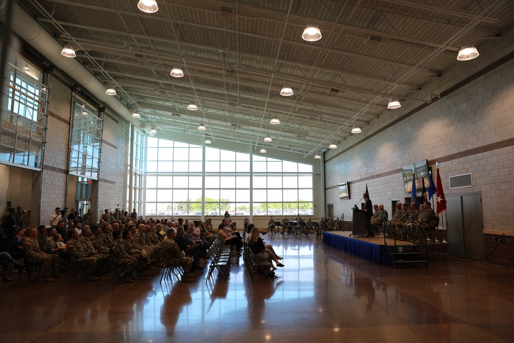 Soldiers and family gather in the assembly room of the South Dakota National Guard Army Aviation Readiness Center to celebrate the activation of a new Army Aviation Unit.