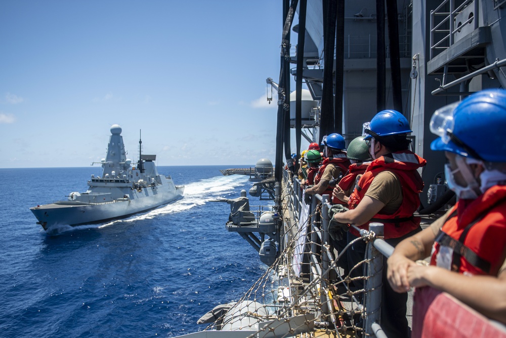Sailors assigned to the forward deployed amphibious assault ship USS America participate in a fueling-at-sea.