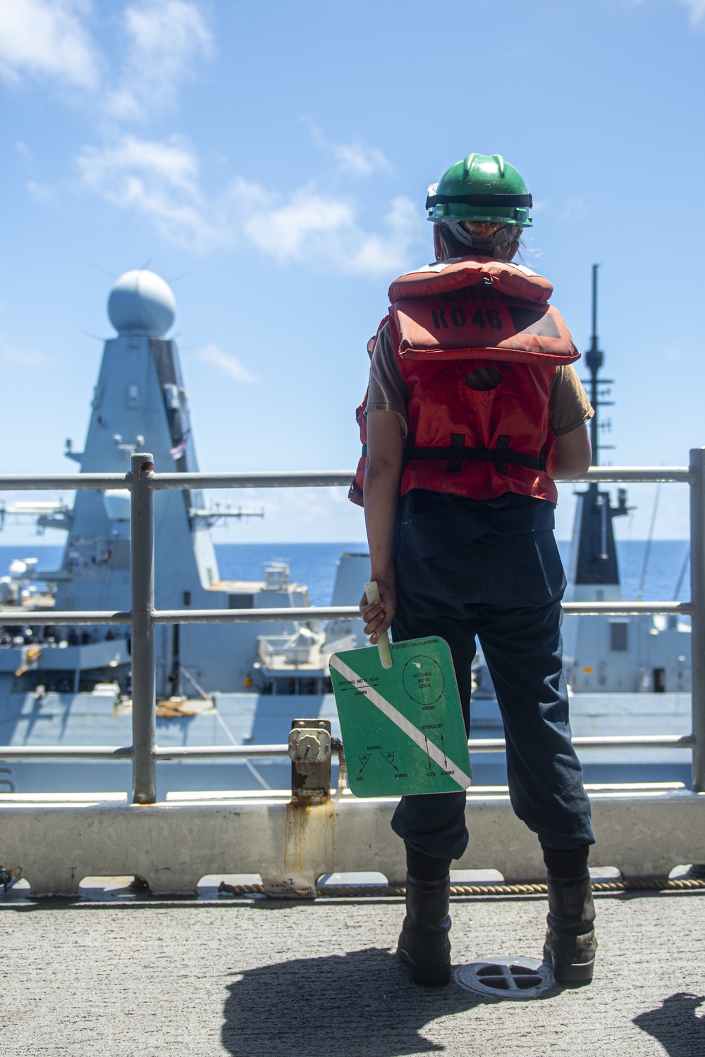 Sailors assigned to the forward deployed amphibious assault ship USS America participate in a fueling-at-sea.