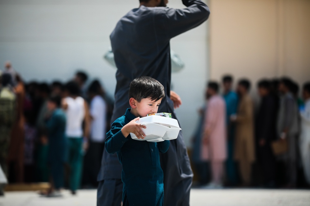 Soldiers assist with the evacuation at Hamid Karzai International Airport