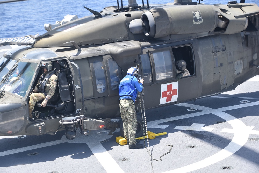 USNS Burlington Sailor Secures a UH-60 Blackhawk Helicopter