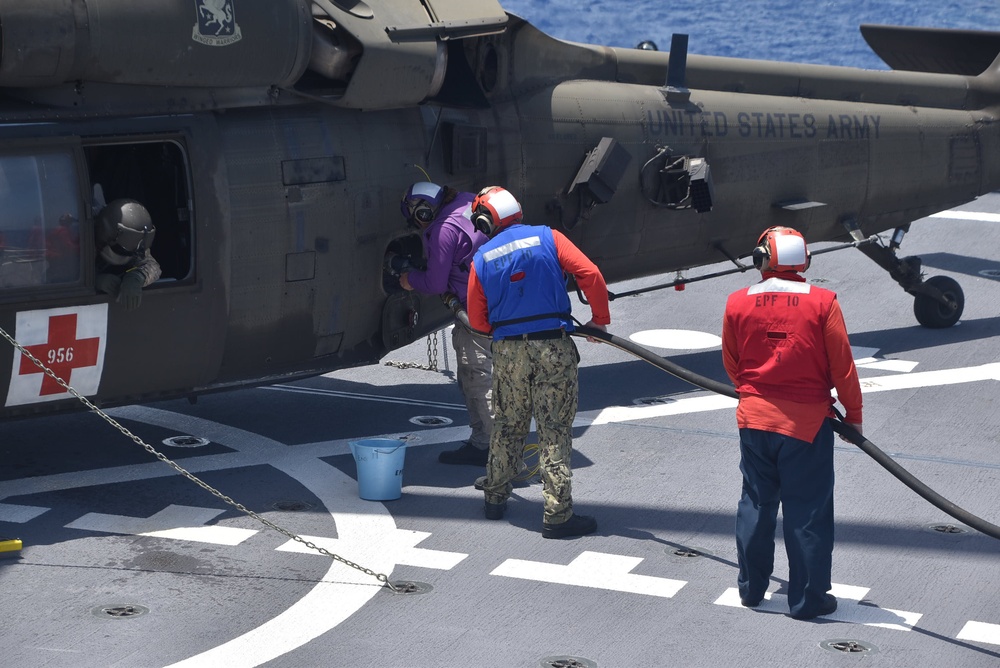 USNS Burlington Sailors Refuel a UH-60 Blackhawk Helicopter