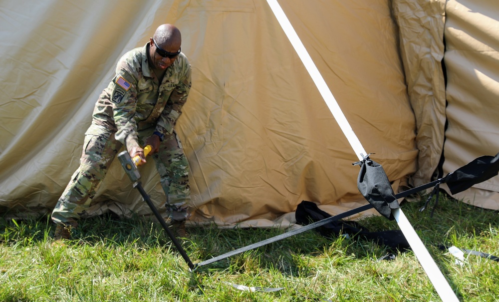 1st Theater Sustainment Commmand Soldiers set up airbeam tent