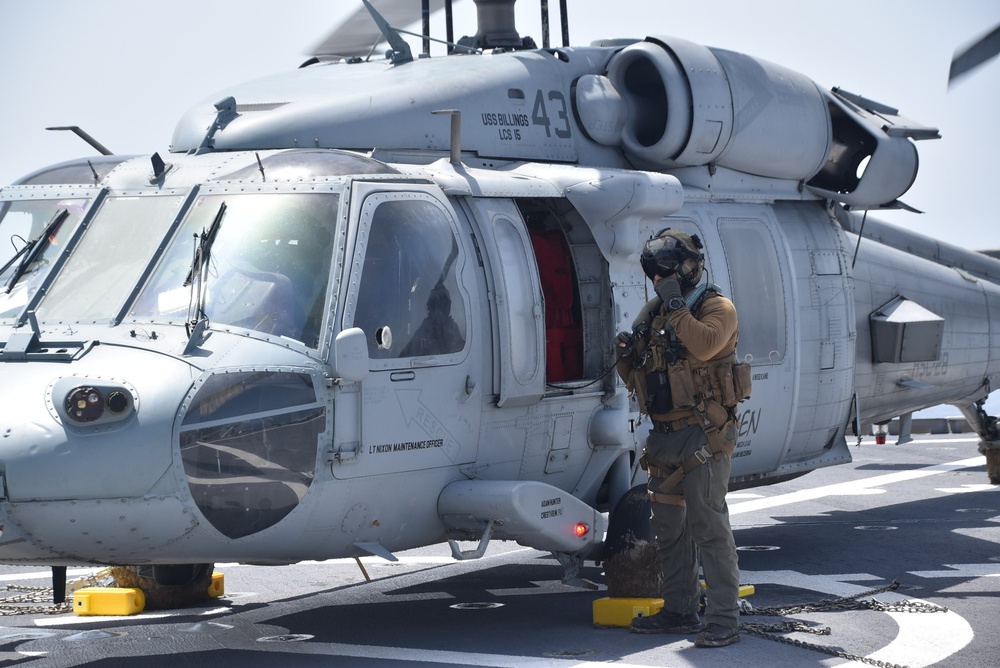 HSC 28 Sailor Prepares an MH-60S Seahawk Helicopter For Refueling