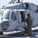 HSC 28 Sailor Prepares an MH-60S Seahawk Helicopter For Refueling