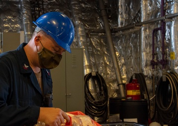 USS Jackson (LCS 6) Sailors perform maintenance on surface tow cradle