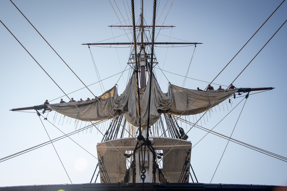 Sailors furl sail aboard USS Constitution