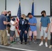 Master Sgt. Selena Tatum's children and husband place Senior Master Sergeant insignia on her shoulders during her promotion ceremony