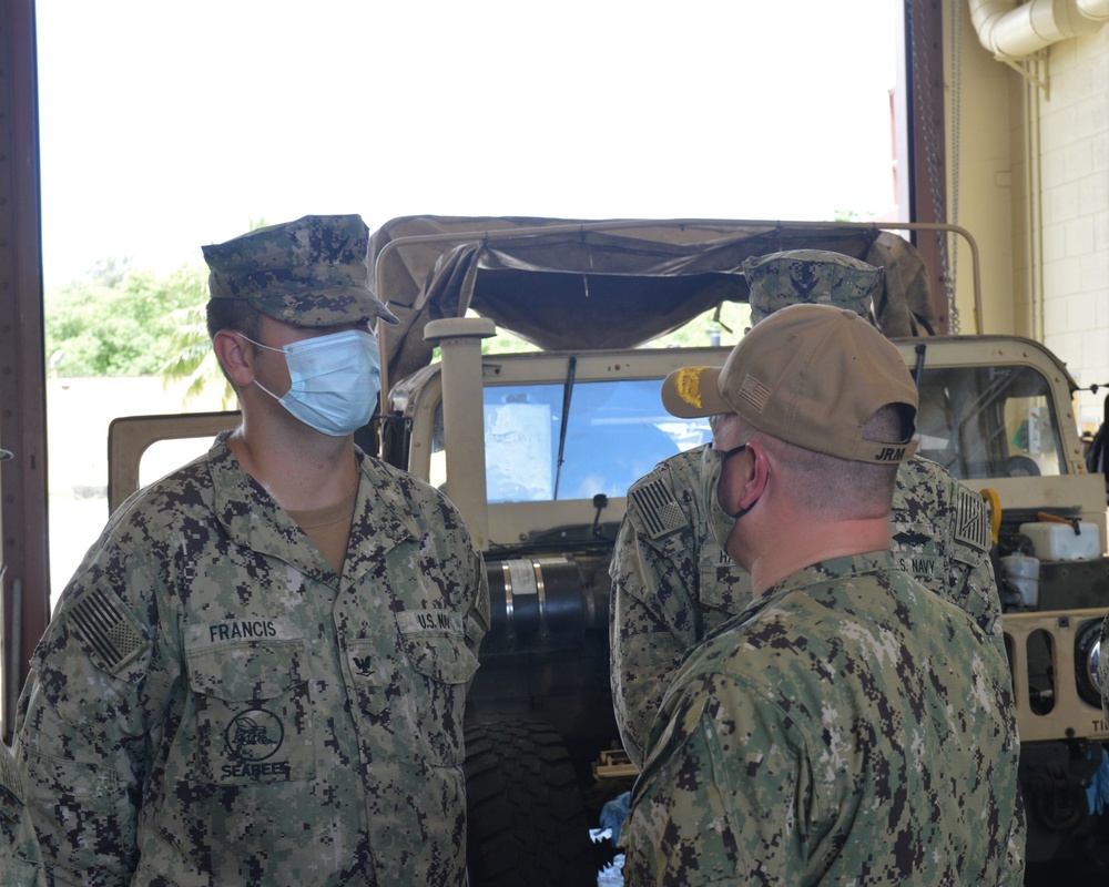 Rear Adm. Nicholson congratulates NMCB 1 Seabee for his support of the UK Strike Group 21 sailors