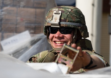 Soldier Opens Palletized Care Items