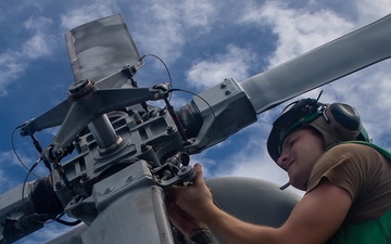 Sailor Conduct Maintenance on an MH-60R Seahawk Aboard USS Michael Murphy (DDG 112)