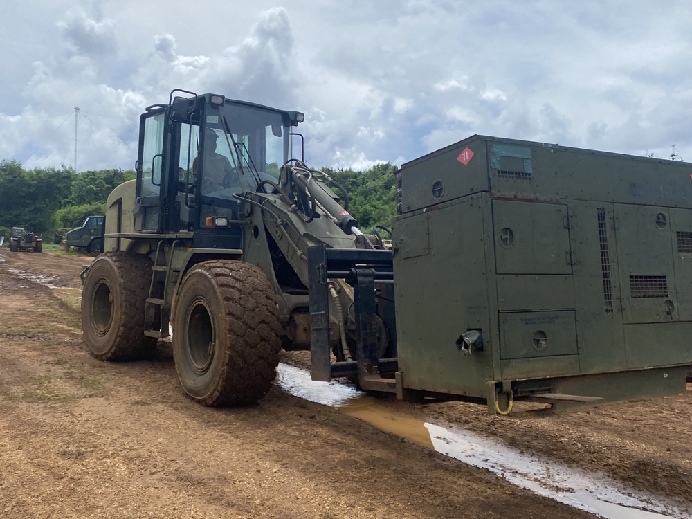 U.S. Navy Seabees assigned to NMCB-5 pave and repair roadways in Tinian, Northern Mariana Islands