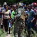 HSC-28 Aircrewman Speaks With Haitians During A Humanitarian Aid Delivery
