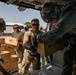 Army Soldiers Help Load A Navy MH-60S Sea Hawk Helicopter With Humanitarian Aid