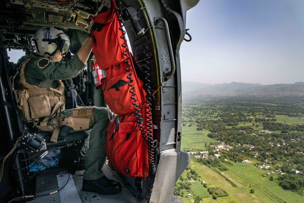 HSC-28 Aircrewman Flies Over Haiti While Supporting Humanitarian Aid Mission