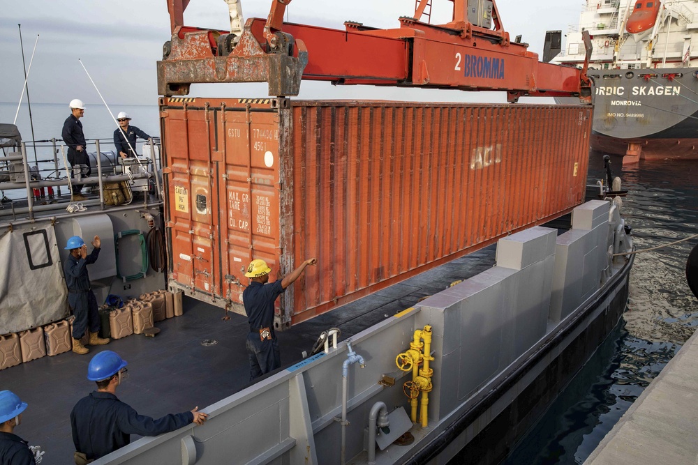 Sailors Load Shipping Container Of Humanitarian Aid Onto A U.S. Navy LCU