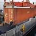 Sailors Load Shipping Container Of Humanitarian Aid Onto A U.S. Navy LCU