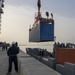 Sailors Load Shipping Container Of Humanitarian Aid Onto A U.S. Navy LCU