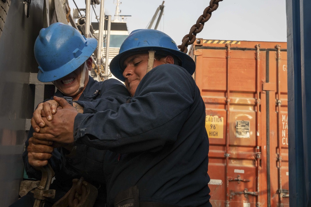 Sailors Secure A Shipping Container Of Humanitarian Aid On A U.S. Navy LCU