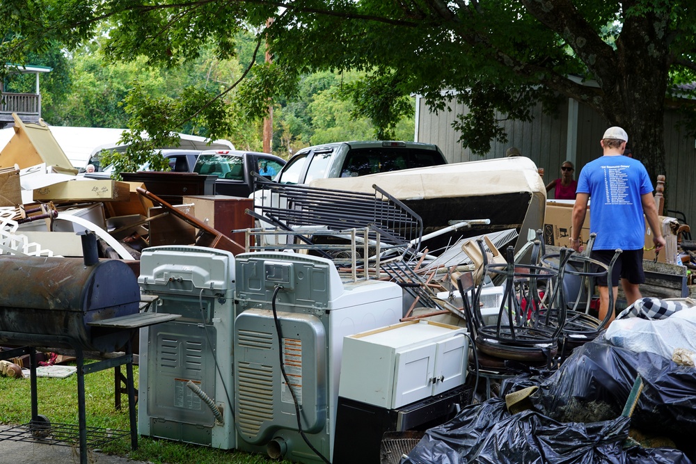 Flood Debris Moved to Edge of Street