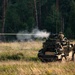 Battle Group Poland's Poacher Troop fires and maneuvers to practice reconnaissance tactics