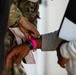 U.S. Army Soldier places a wristband on Afghan evacuee during Operation Allies Welcome at Fort Pickett, Virginia.