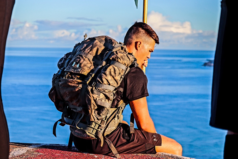 Staff Sgt. Brandon Stubbs sits to recover after a physically taxing hike to the Ma'ili Pillboxes.