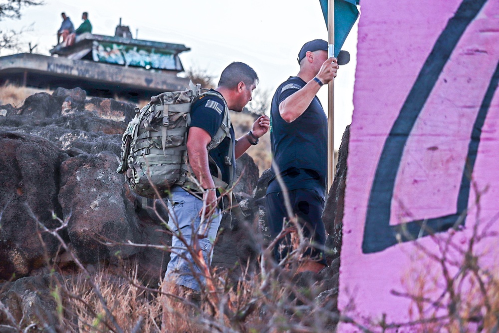 Sgt. First Class Javier Cardenas(right) and Staff Sgt. Robert Darden(left, with Guidon) admires the view of the shores by the Ma'ili Pillboxes.