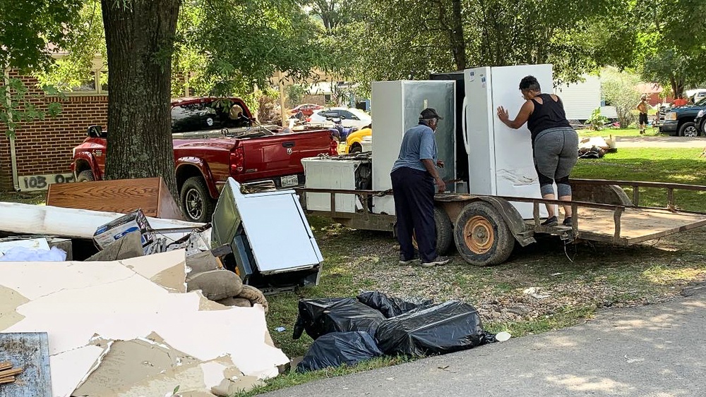 Survivors of Flooding Removing Damaged White Goods