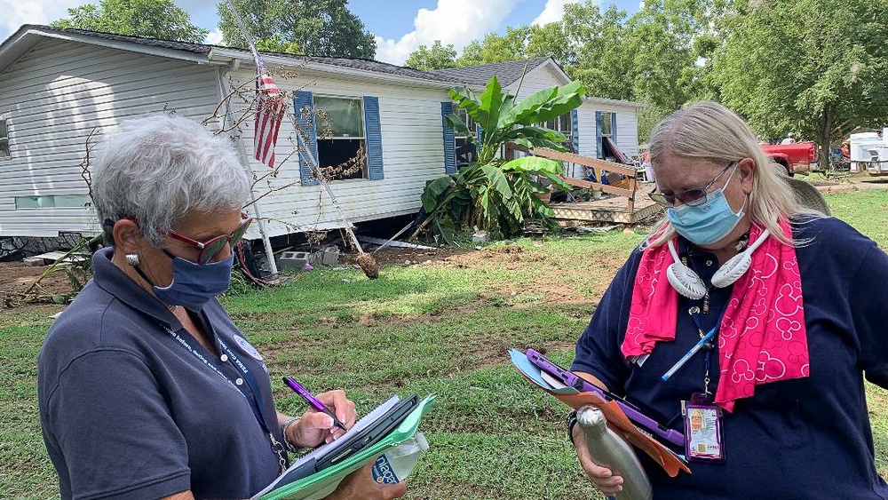 FEMA Comparing Data While Canvassing Hard Hit Community