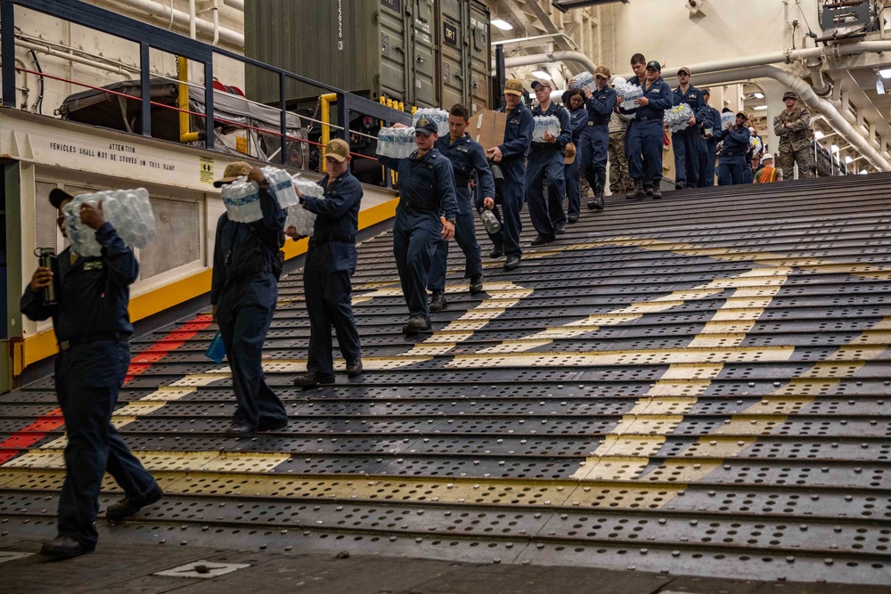 USS Arlington Sailors Load An LCU With Humanitarian Aid