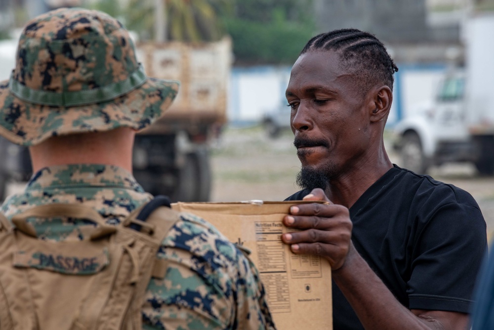 Haitians and Marines Work Together During Humanitarian Aid Mission in Haiti