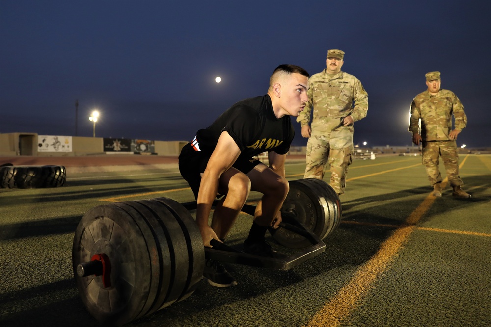 Spc. Christopher Dame completes the dead lift event during the ACFT at the Task Force Spartan best warrior competition in Kuwait