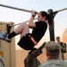 Spc. Grace Tsen completes the leg tuck event during the ACFT at the Task Force Spartan best warrior competition in Kuwait