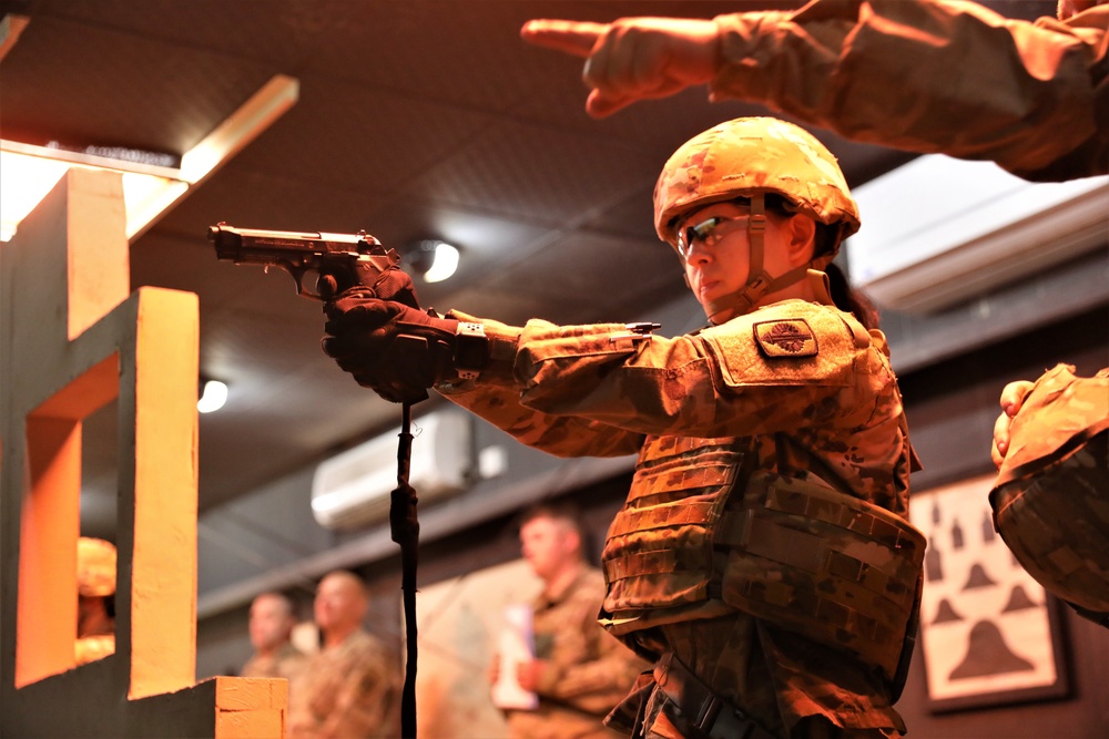 Spc. Grace Tsen completes the indoor range event during the Task Force Spartan best warrior competition in Kuwait